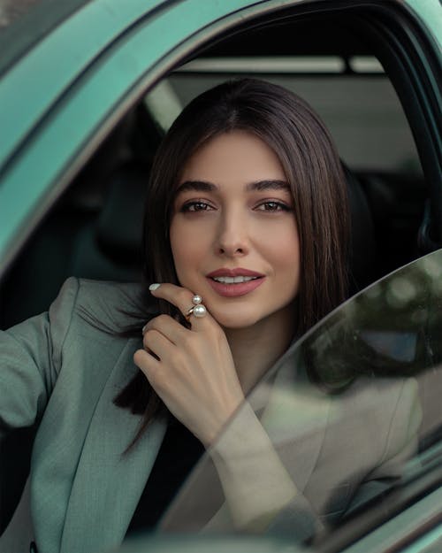 Beautiful Brunette Woman Sitting in the Car 