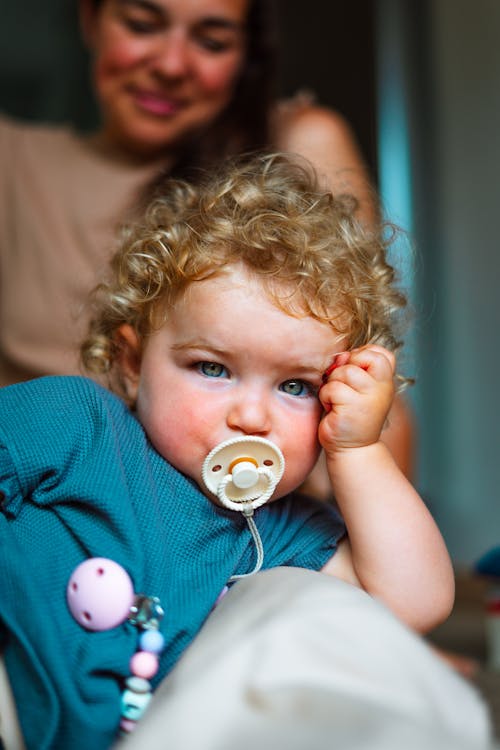 A Young Girl with Pacifier on her Mouth