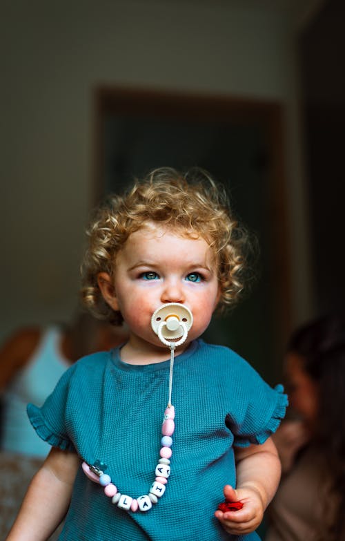 A Cute Little Baby Girl Using Pacifier