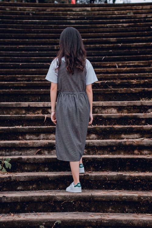 Woman Standing on Gray Concrete Stairs