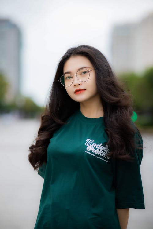 A Woman in Green Shirt Wearing Eyeglasses