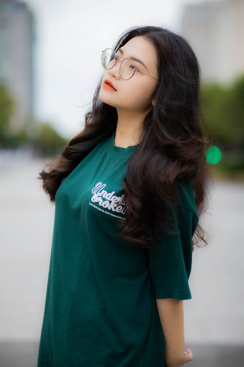 Photo of a Woman in Green Shirt Wearing Eyeglasses