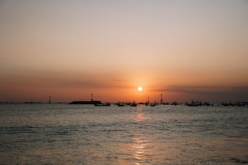 Silhouette of Boats on Beach during Sunset