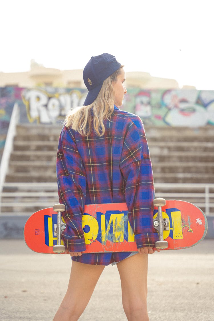 A Woman Carrying A Skateboard 