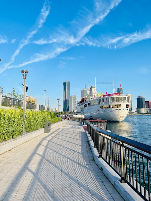 White Ship on Sea Beside a Sidewalk 