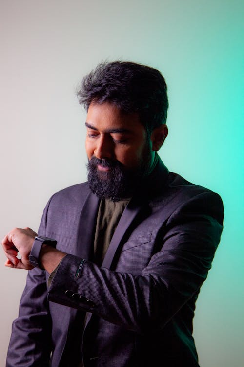 A Bearded Man Looking at His Watch