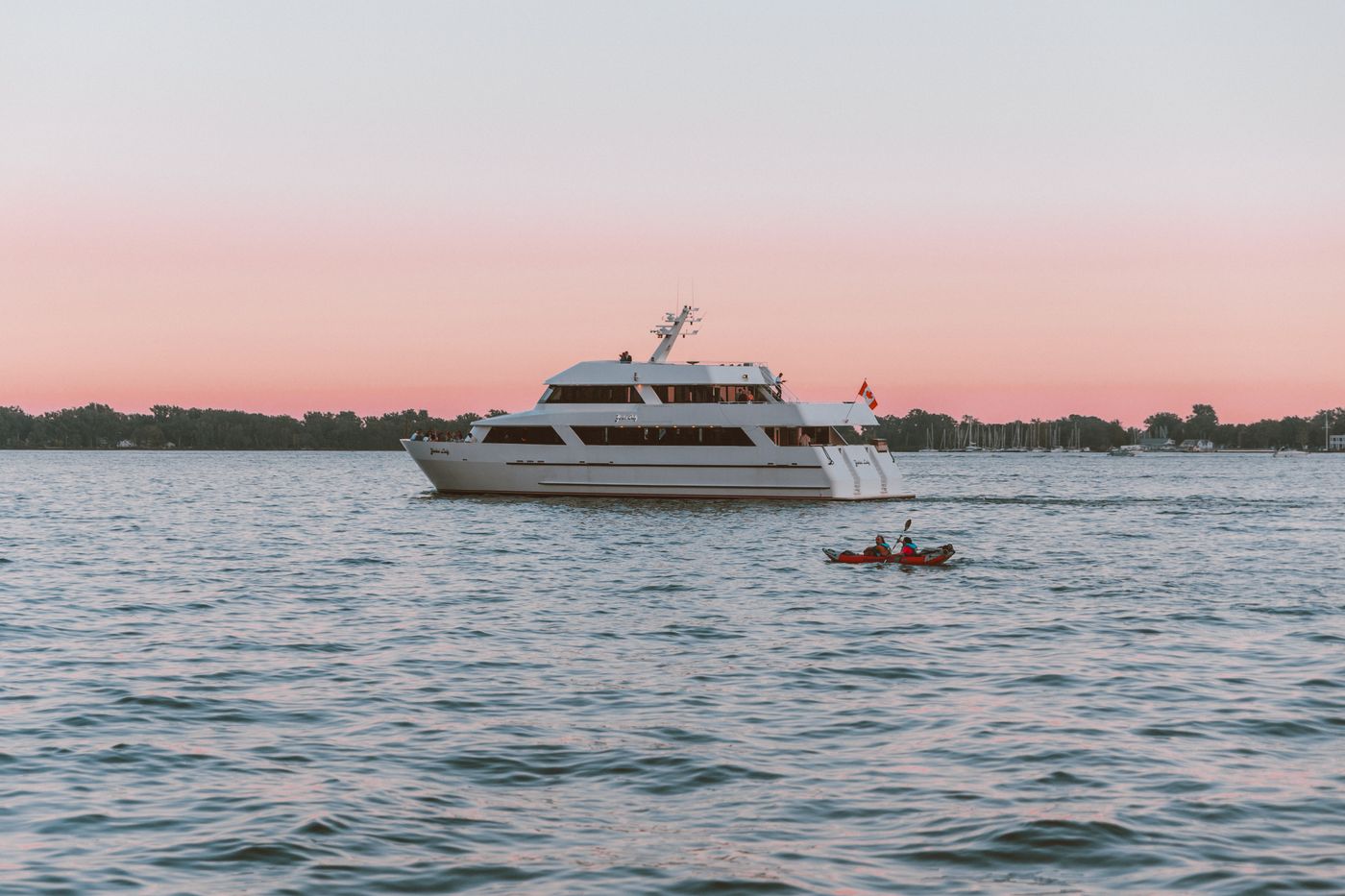 71-metre yacht at anchor beneath a rose-coloured dusk sky