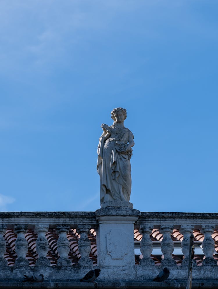 Statue On Concrete Railing