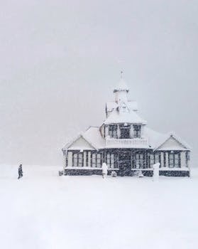 Elegant Victorian house amidst a snowy landscape in Ushuaia during winter, creating a serene scene.
