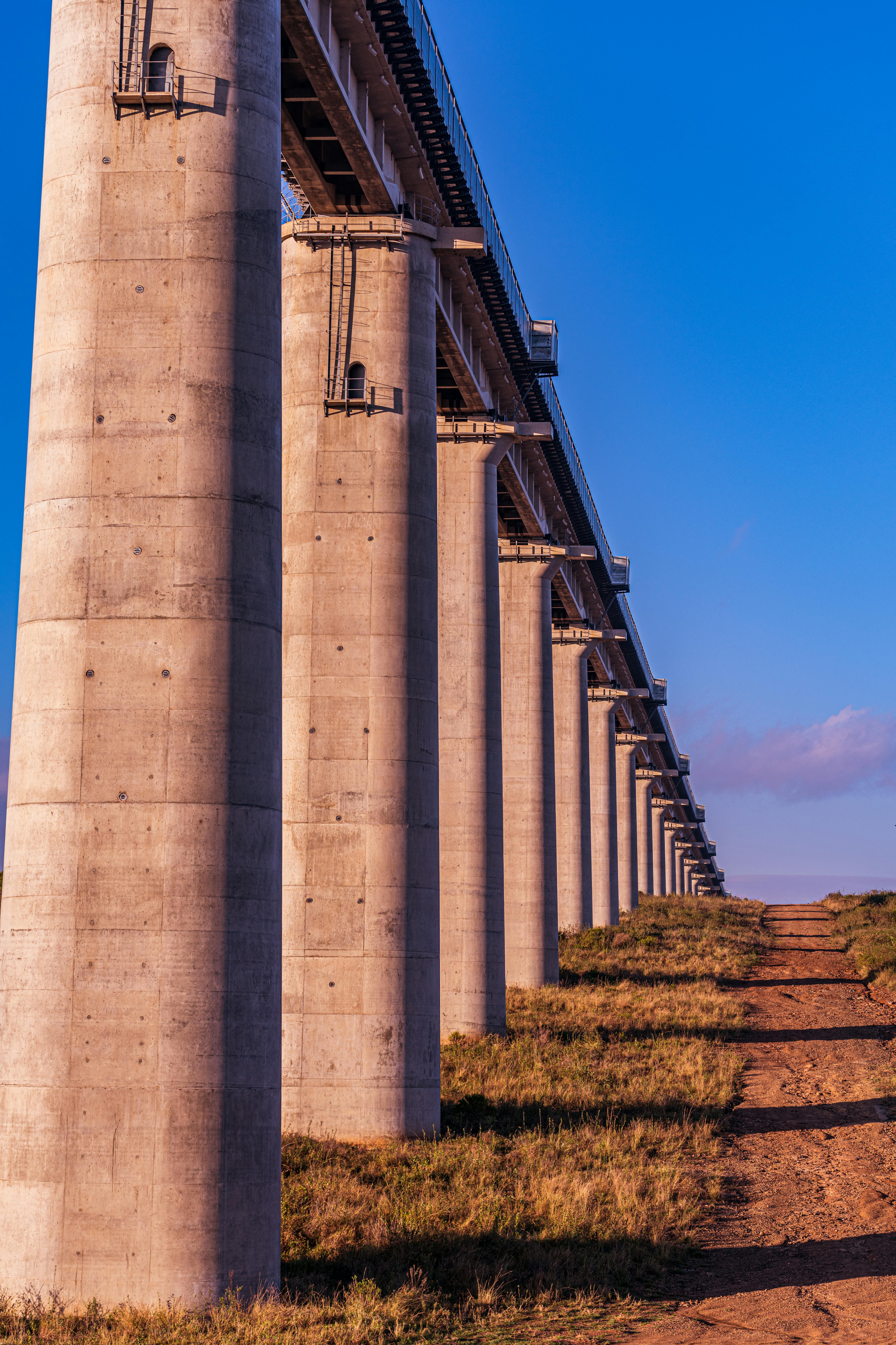 Bridge Pillars of an Elevated Railway Line Under Blue Sky · Free Stock