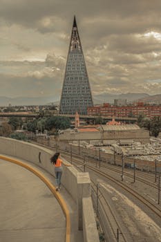 Cityscape of Mexico City featuring unique triangular tower and urban landscape.