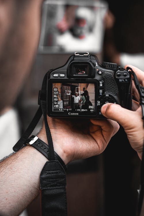 Man Taking Picture Using a DSLR Camera 