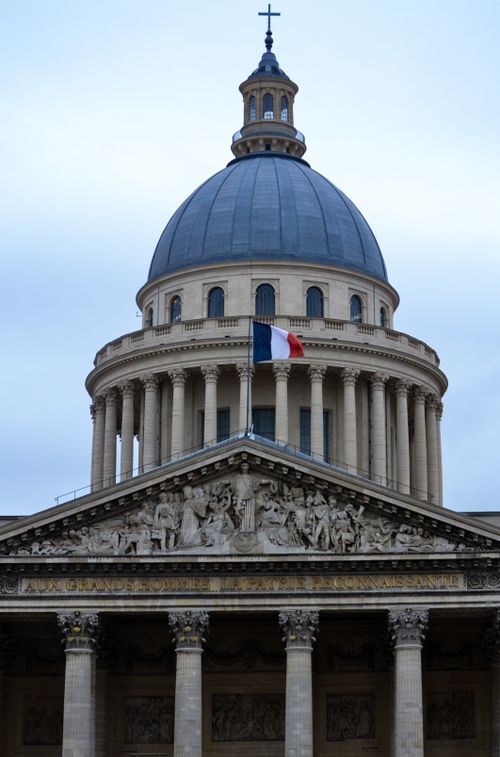 Free Low-angle view of the Pantheon dome in Paris, France with the French flag flying. Stock Photo