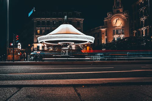 Time Lapse Photography of a Carousel Near the Street at Night