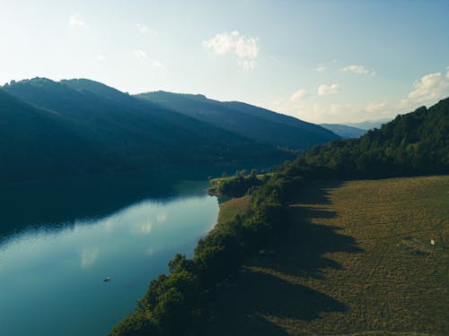 An Aerial Shot of a River beside Mountains