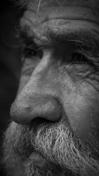 Close-up grayscale portrait capturing the essence of an elderly man's face.