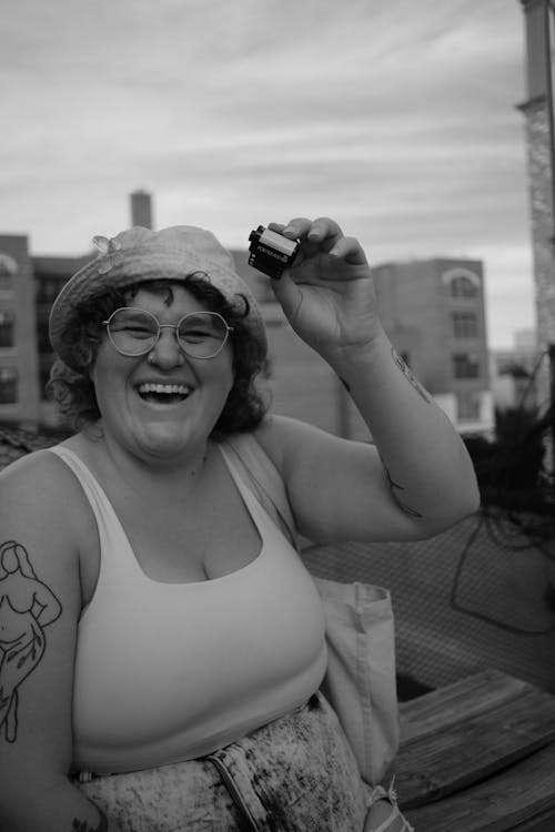 Woman in Tank Top Wearing Eyeglasses in Grayscale Photography 