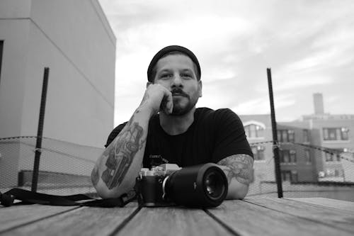 Grayscale Photo of a Man in Black Shirt