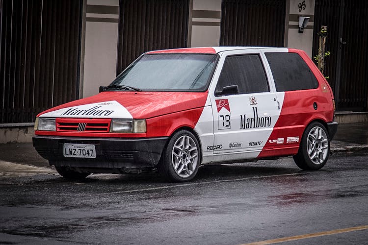 A Fiat Uno Car With Brand Stickers