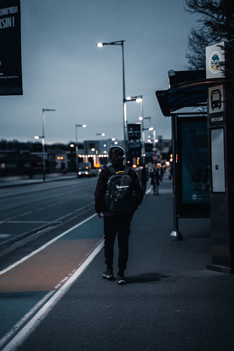 A Person Waiting On A Bus Stop