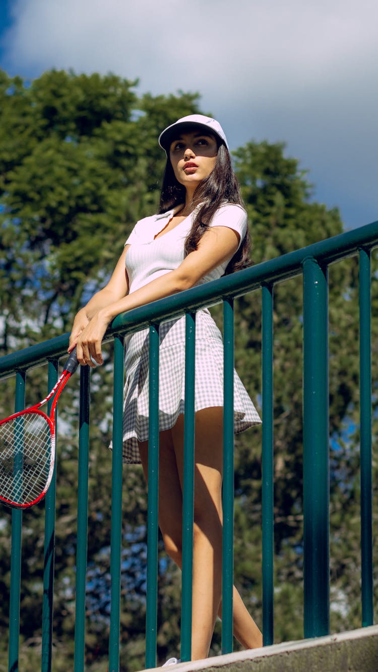 A Woman Holding A Tennis Racket