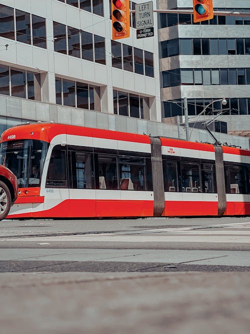 Red and White Tram on Road