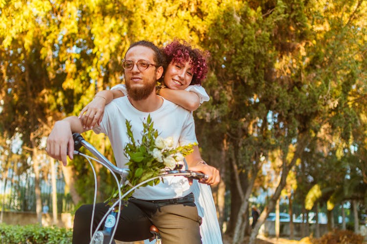 A Couple Riding A Bicycle