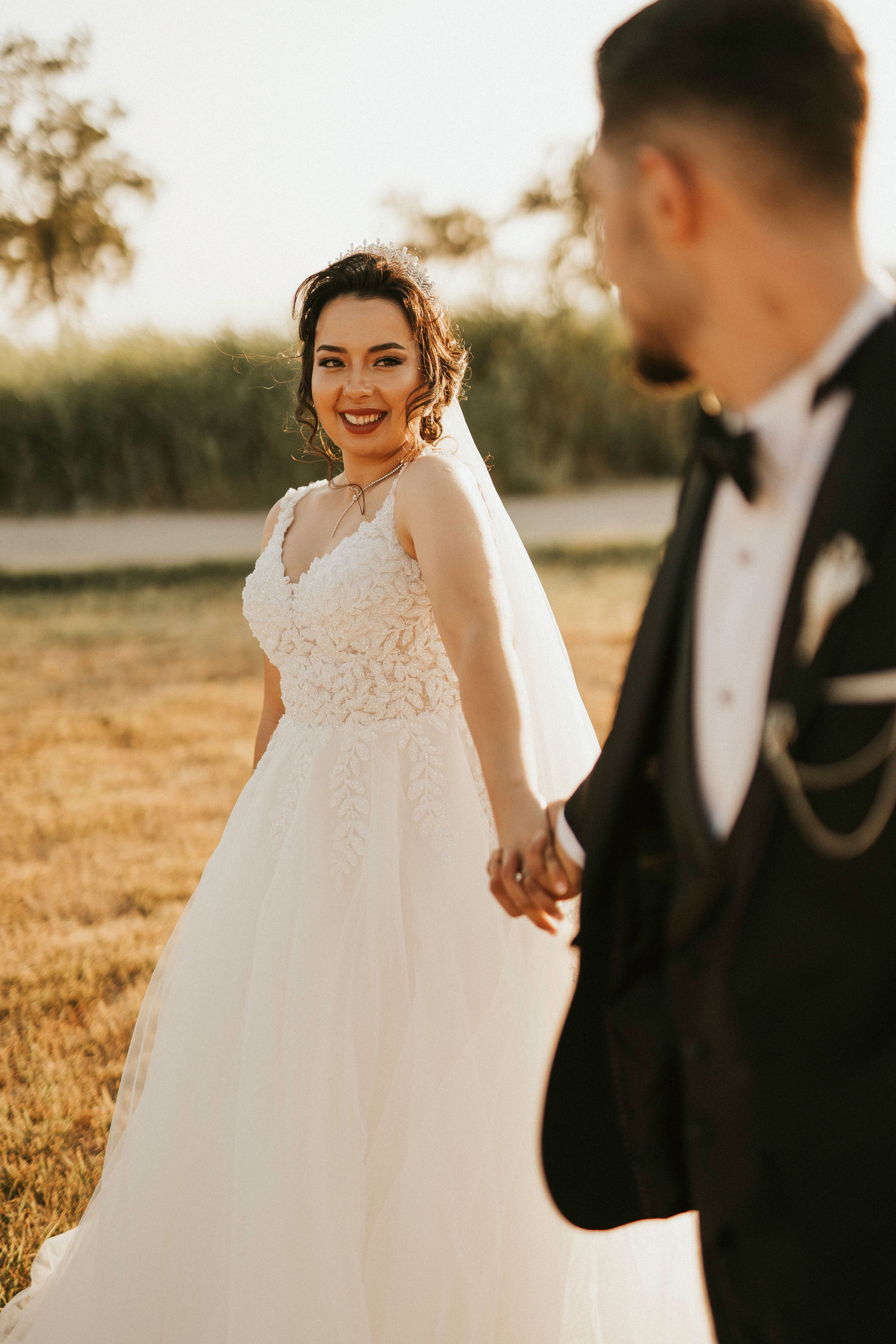 A Bride and Groom Holding Hands · Free Stock Photo
