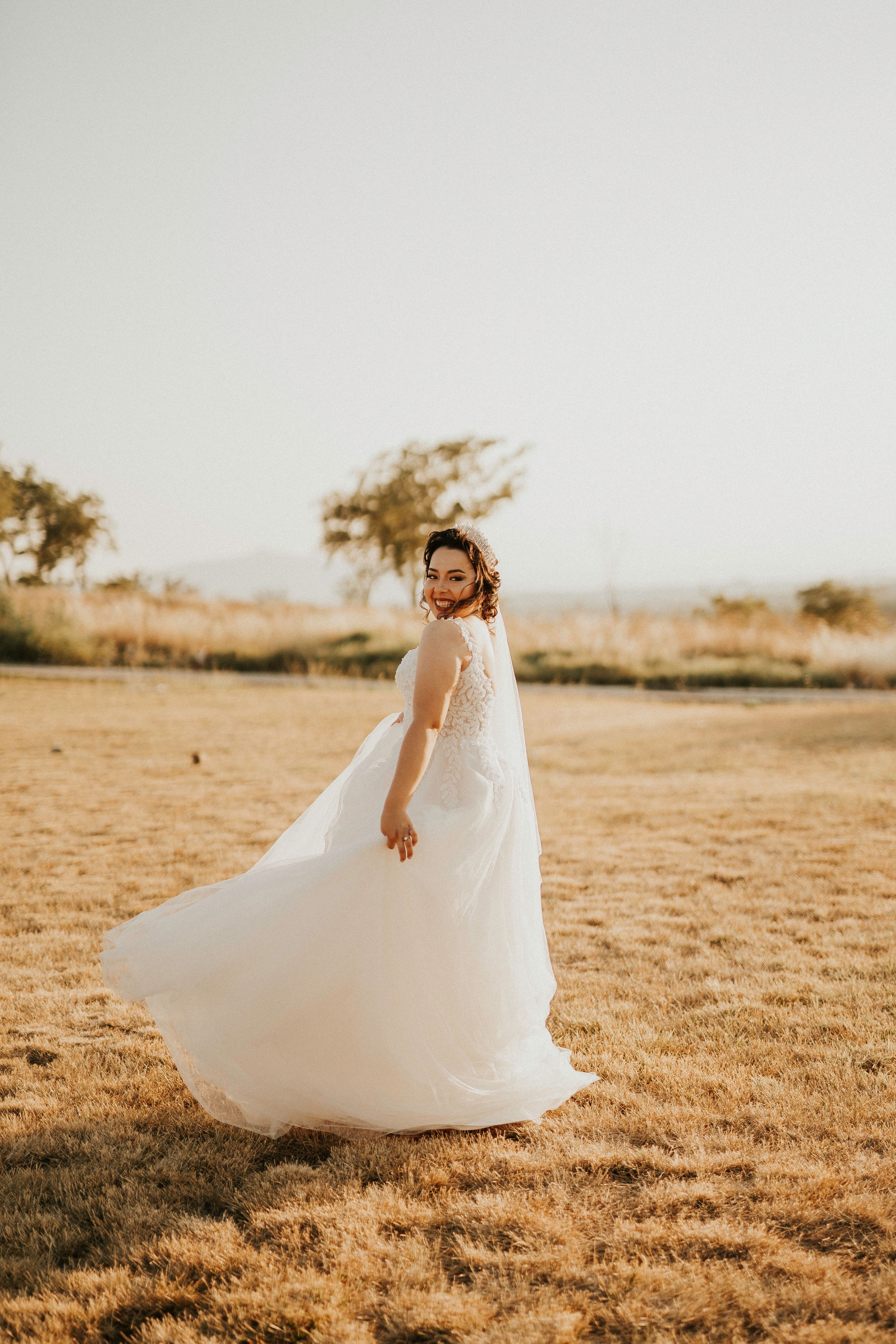 Woman in White Wedding Dress Standing on Brown Grass Field · Free Stock ...