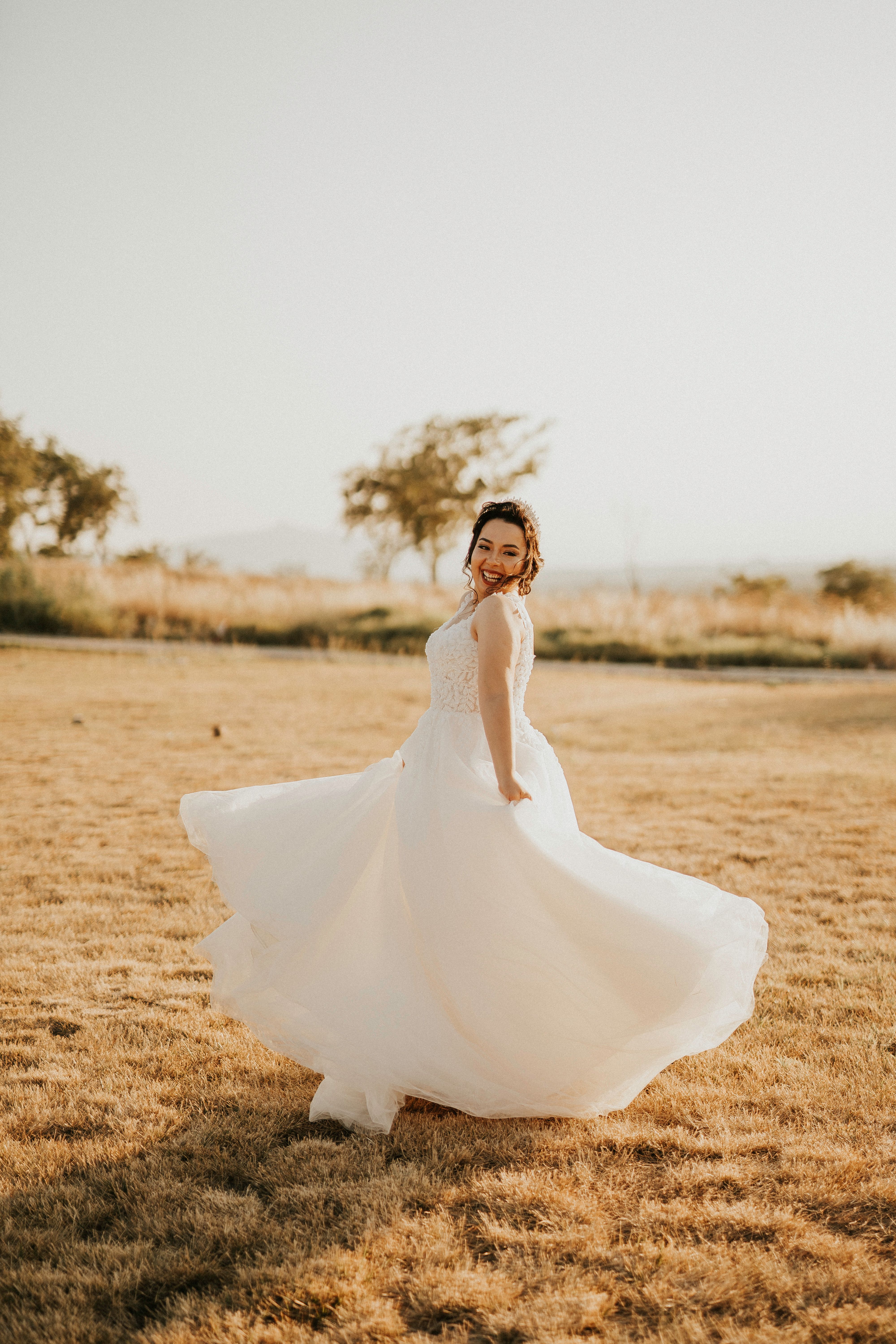 Woman in White Wedding Dress Standing on Brown Grass Field · Free Stock ...
