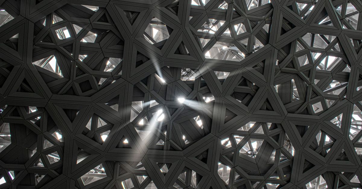 Sunlight filters through the geometric roof of Louvre Abu Dhabi, creating a stunning pattern.