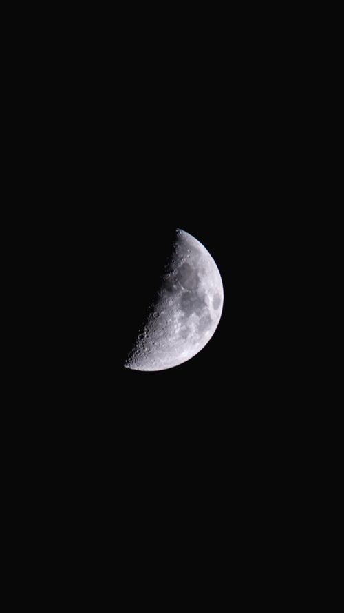 Free A striking vertical shot of the half moon set against a dark night sky in Tecate, Mexico. Stock Photo