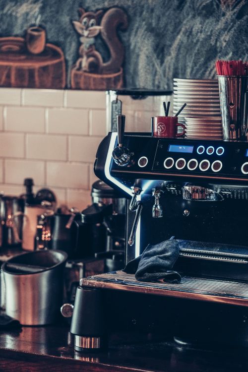 Free Close-up of a stylish espresso machine in a trendy cafe setting, perfect for coffee lovers. Stock Photo