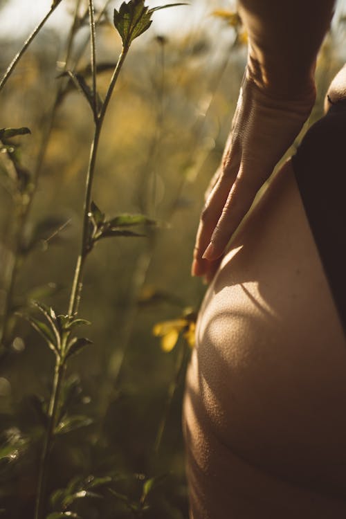 Green Pant Beside a Person's Buttock