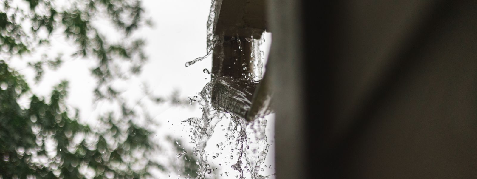 Rainwater pouring out of a gutter in Houston