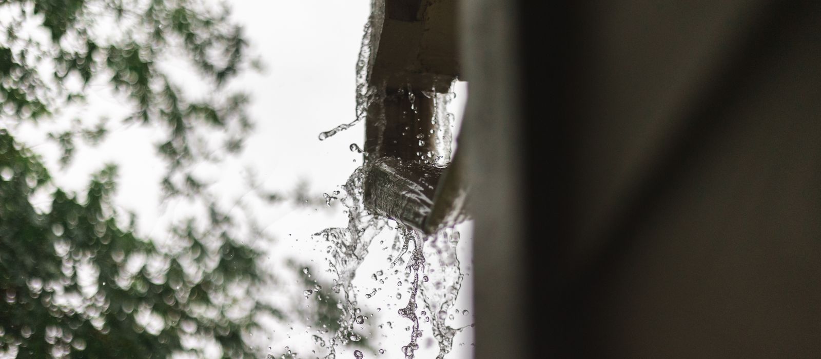 Rainwater pouring out of a gutter in Houston