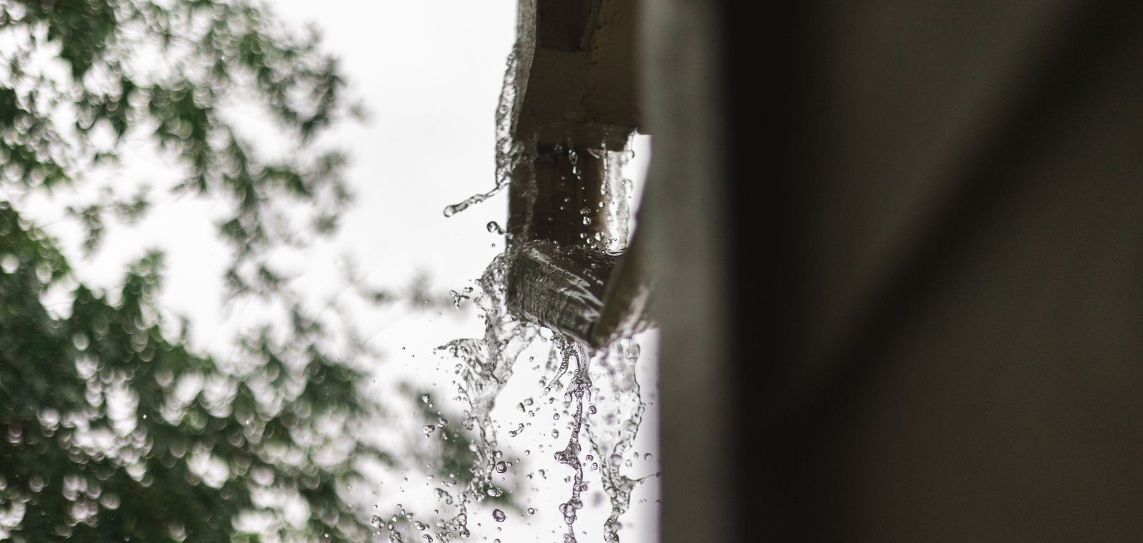Rainwater pouring out of a gutter in Houston