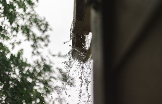 Rainwater pouring out of a gutter in Houston