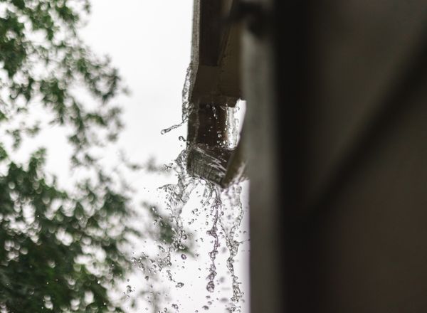Rainwater pouring out of a gutter in Houston