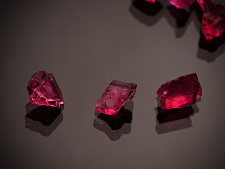 Red Gemstones On A Black Surface