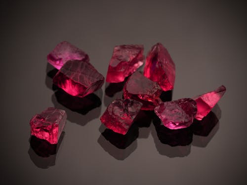 Red Gemstones on a Black Surface