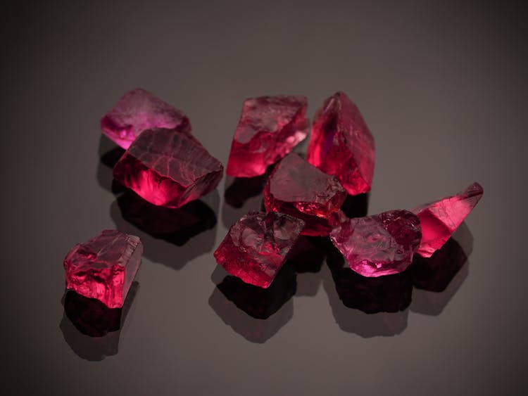 Red Gemstones On A Black Surface