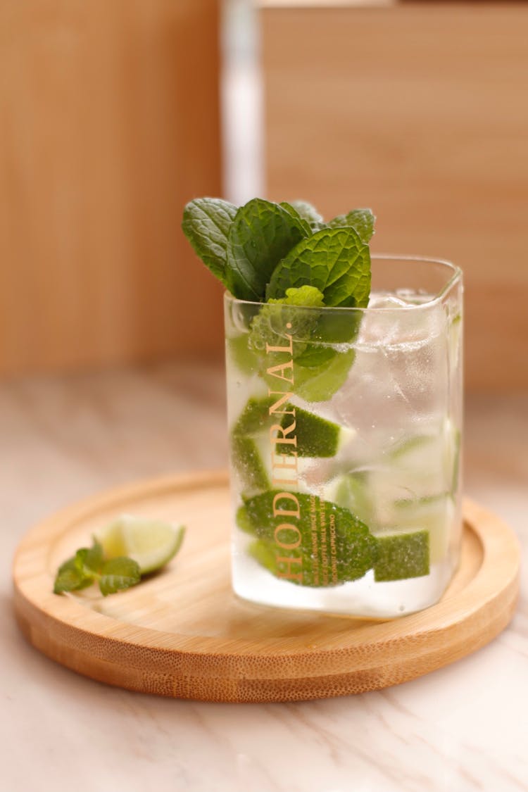 Slices Of Lime And Mint Leaves In A Glass With Cold Water