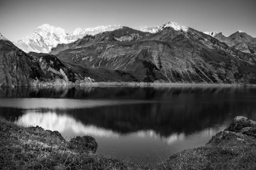 Grayscale of a Lake Near Rocky Mountains