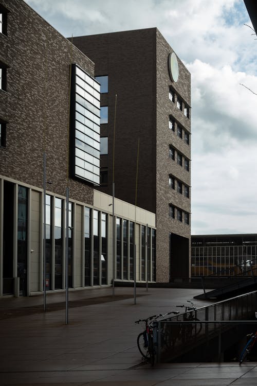 Brown and White Concrete Building Under White Clouds