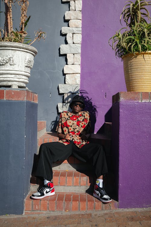 Man in Floral Polo Posing on the Stairs