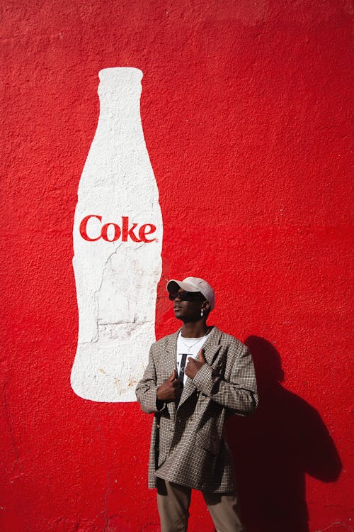 Model Posing against Coke Mural