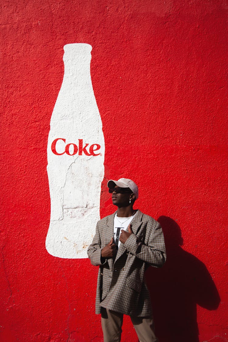 Model Posing Against Coke Mural