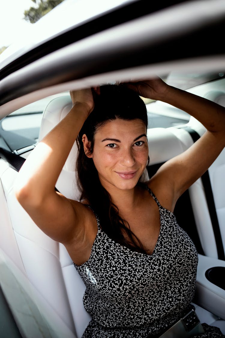 Woman Sitting Inside A Car And Smiling 