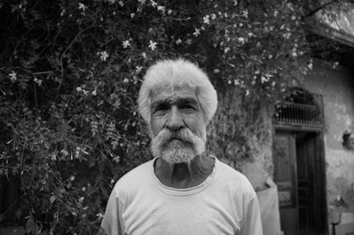 Grayscale Photo of an Elderly Man with Beard